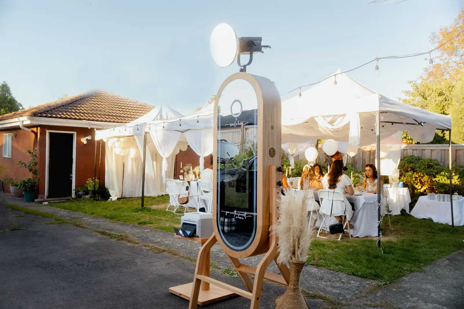 Photo booth rental setup with printed photos displayed at a Vancouver event